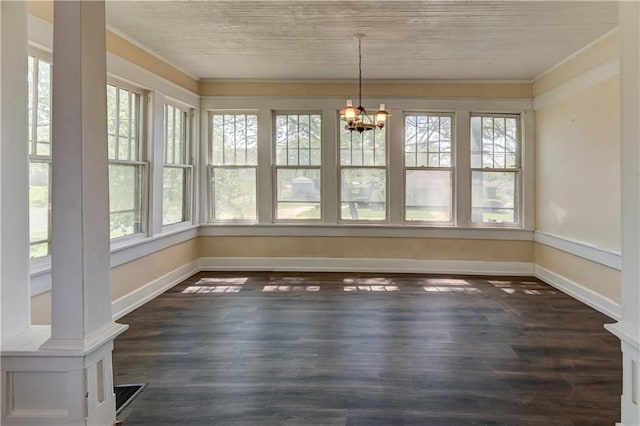 unfurnished dining area with baseboards, dark wood-style floors, a chandelier, and crown molding