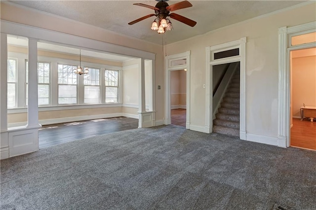 unfurnished living room featuring stairway, ornamental molding, carpet, and a ceiling fan