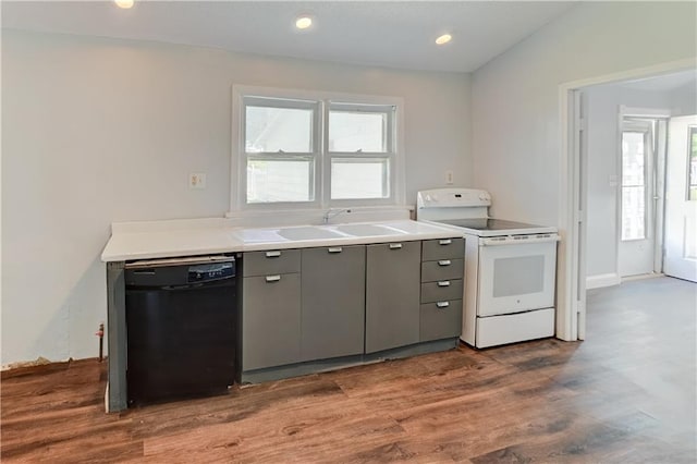 kitchen featuring black dishwasher, electric stove, a sink, gray cabinetry, and dark wood-style floors