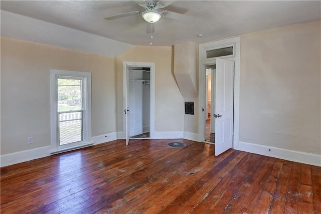 unfurnished bedroom with baseboards, visible vents, a ceiling fan, and wood-type flooring