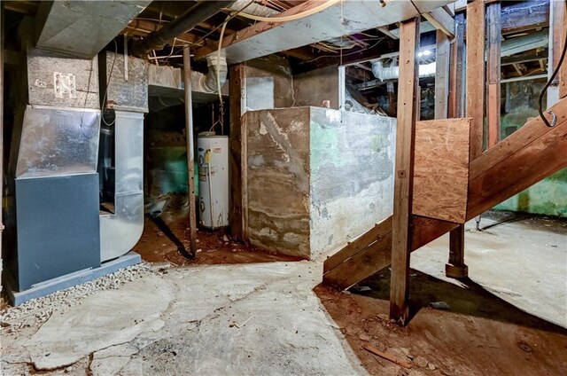 unfinished below grade area featuring heating unit and water heater