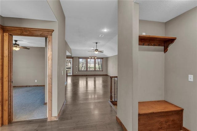 hall featuring baseboards, recessed lighting, and wood finished floors