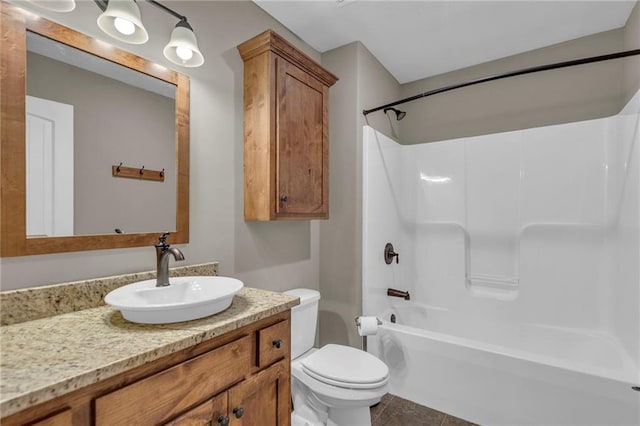 bathroom with toilet, tile patterned flooring,  shower combination, and vanity