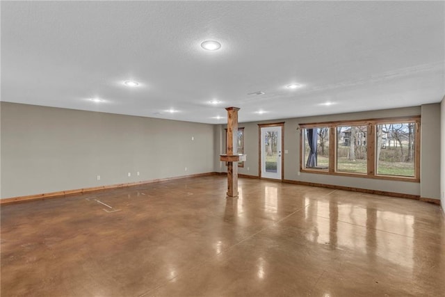 interior space with ornate columns, finished concrete floors, recessed lighting, and baseboards