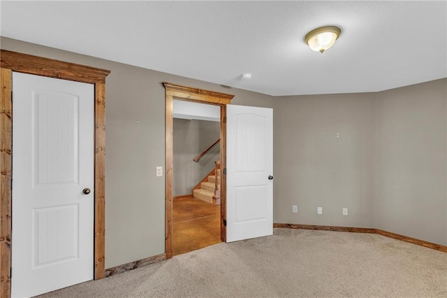 unfurnished bedroom with baseboards and carpet floors