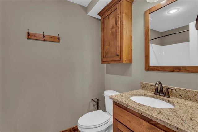bathroom featuring toilet and vanity
