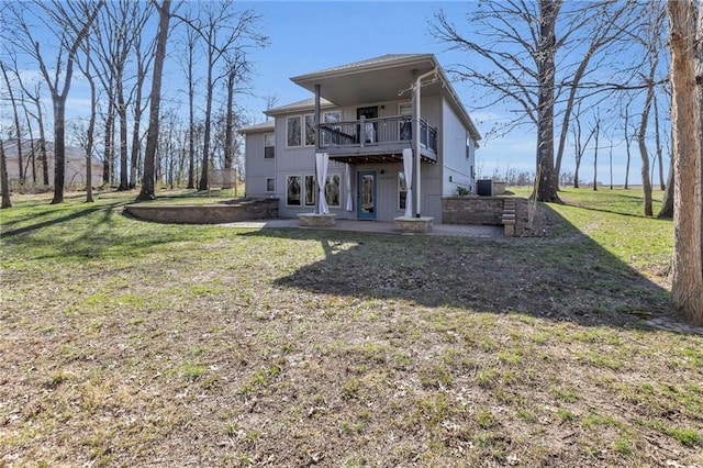 rear view of house with a deck and a yard