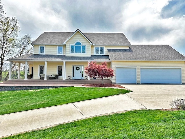 8225 NE 124th St, Kansas City, MO 64167 - view of front of home with a garage, driveway, a front lawn, and covered porch