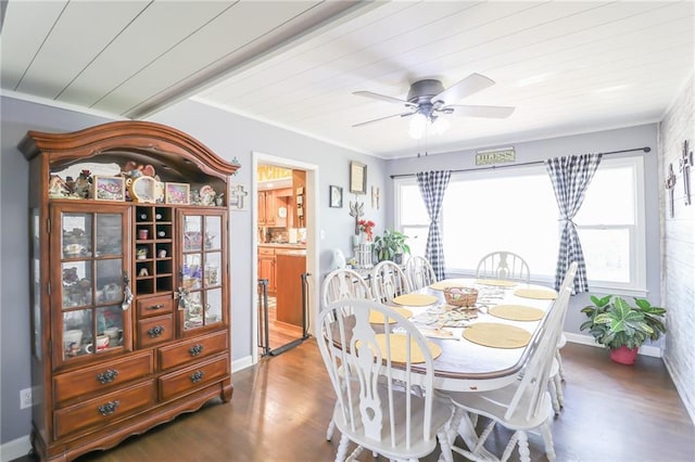 dining room featuring crown molding, wood finished floors, baseboards, and a ceiling fan