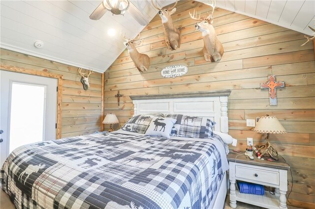 bedroom with wood walls, ceiling fan, and lofted ceiling