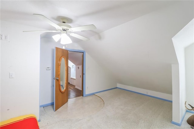 additional living space with ceiling fan, vaulted ceiling, and baseboards