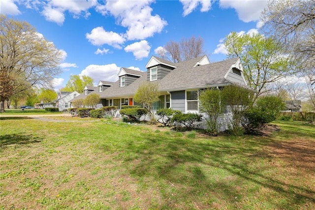 view of home's exterior featuring roof with shingles and a yard