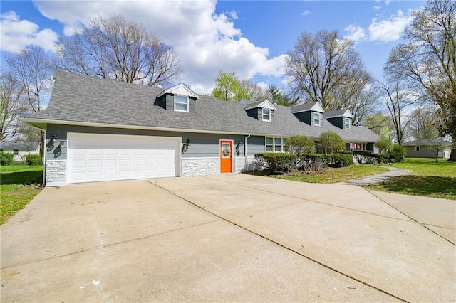 new england style home with a garage, driveway, stone siding, and a shingled roof
