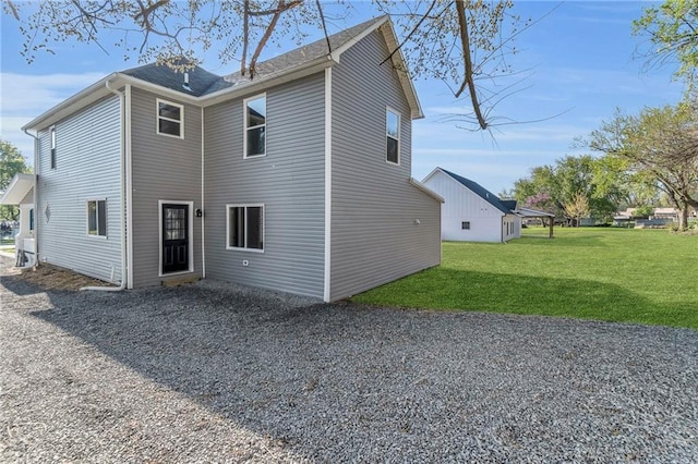 613 N Mead St, Cameron, MO 64429 - back of house featuring a lawn and driveway