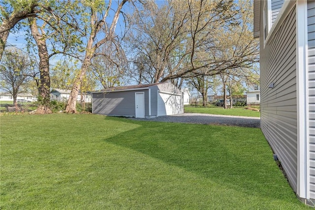 613 N Mead St, Cameron, MO 64429 - view of yard featuring driveway, an outbuilding, and a detached garage