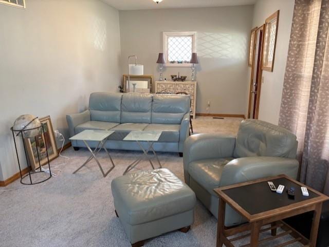 carpeted living area featuring baseboards