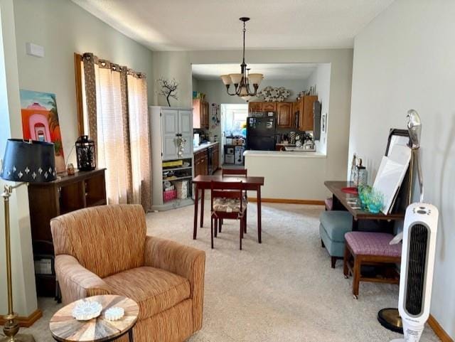 dining area featuring light carpet and a chandelier