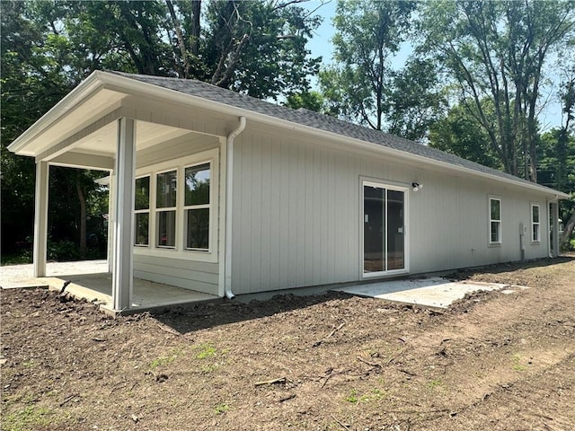 320 E 2nd St, Adrian, MO 64720 - back of property featuring a patio and roof with shingles