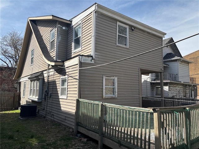 view of property exterior with cooling unit and a fenced backyard