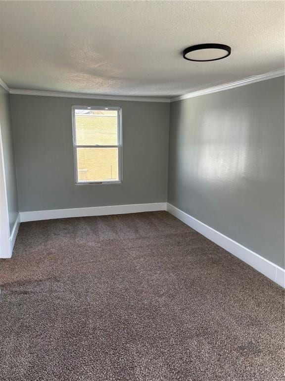 unfurnished room with a textured ceiling, ornamental molding, baseboards, and dark colored carpet