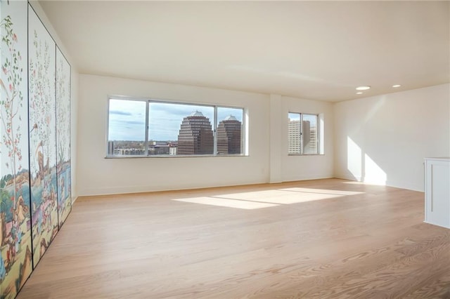 empty room featuring light wood-style floors and recessed lighting