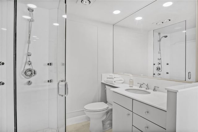 bathroom featuring a shower stall, toilet, vanity, and recessed lighting