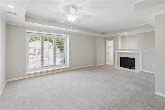 5329 Park St, Shawnee, KS 66216 - unfurnished living room featuring a tray ceiling, crown molding, carpet flooring, a tiled fireplace, and a ceiling fan