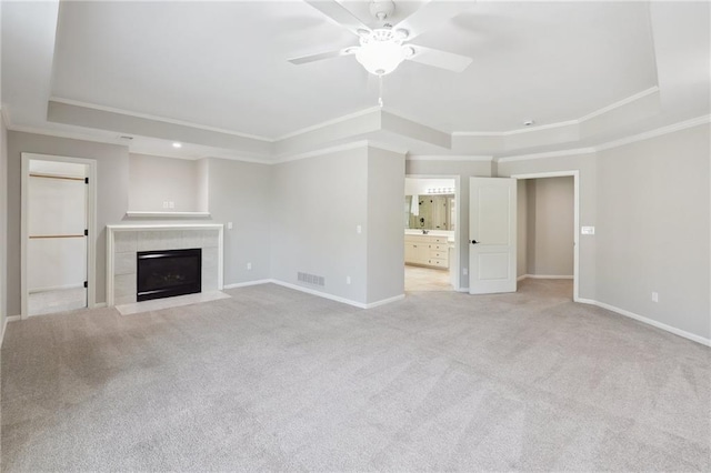 5329 Park St, Shawnee, KS 66216 - unfurnished living room featuring a raised ceiling, crown molding, baseboards, ceiling fan, and light colored carpet