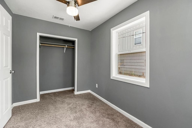 unfurnished bedroom with baseboards, visible vents, a closet, and carpet