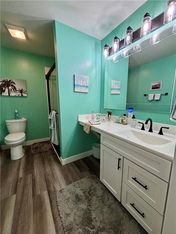 1519 Niagara St, Burlington, KS 66839 - bathroom with toilet, a shower stall, baseboards, and wood finished floors