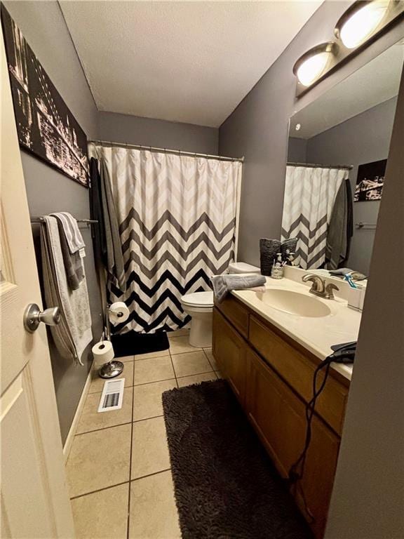 1519 Niagara St, Burlington, KS 66839 - bathroom featuring vanity, toilet, a shower with shower curtain, tile patterned floors, and visible vents