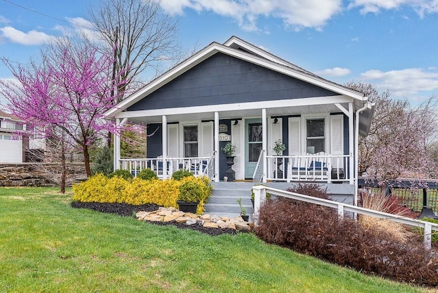 bungalow-style house featuring a front yard and covered porch