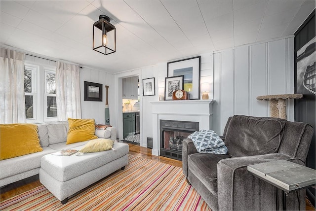 living room with a fireplace and wood finished floors