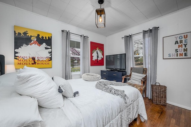 bedroom featuring baseboards and hardwood / wood-style flooring
