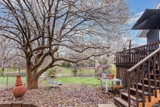 view of yard with a fenced backyard and stairway