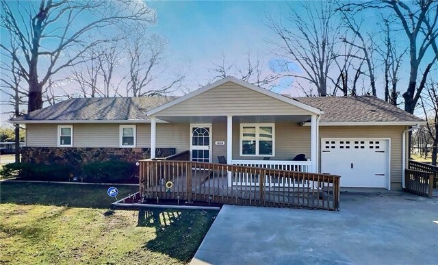 1804 S Phillips St, El Dorado Springs, MO 64744 - single story home with an attached garage, aphalt driveway, and covered porch