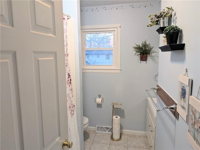 bathroom featuring toilet, baseboards, visible vents, and tile patterned flooring
