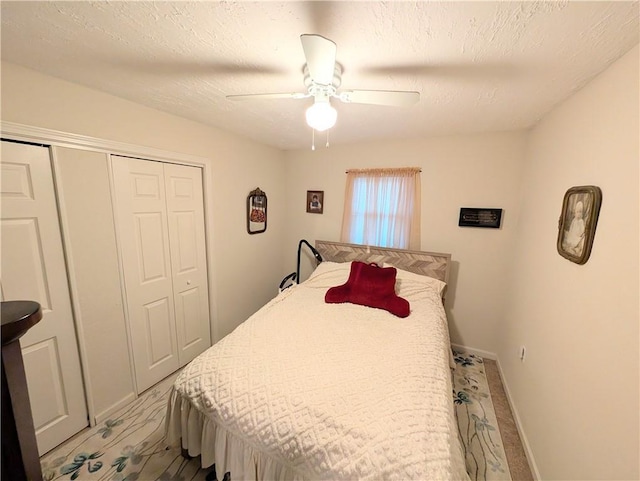 bedroom with a closet, baseboards, and ceiling fan