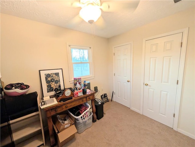 office area featuring carpet flooring, ceiling fan, and baseboards