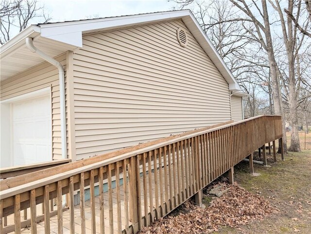 1804 S Phillips St, El Dorado Springs, MO 64744 - view of home's exterior with a garage and a wooden deck