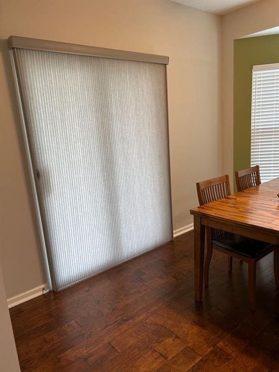 dining area with baseboards and hardwood / wood-style floors