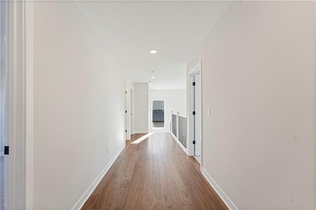 503 Woodview Dr, Raymore, MO 64083 - corridor with dark wood-type flooring, baseboards, and recessed lighting