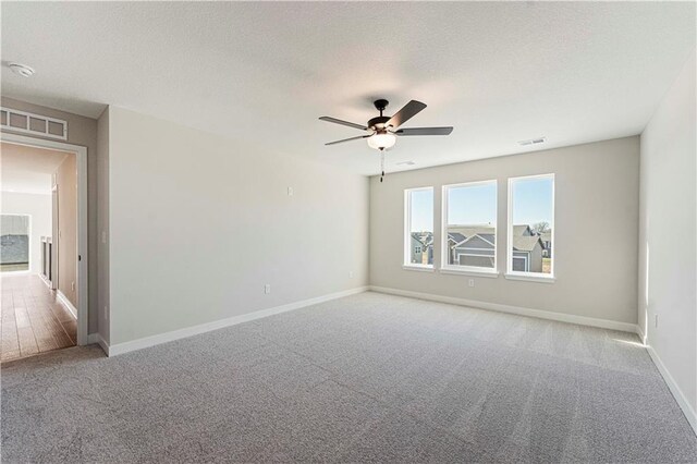503 Woodview Dr, Raymore, MO 64083 - empty room with carpet flooring, baseboards, a ceiling fan, and a smoke detector