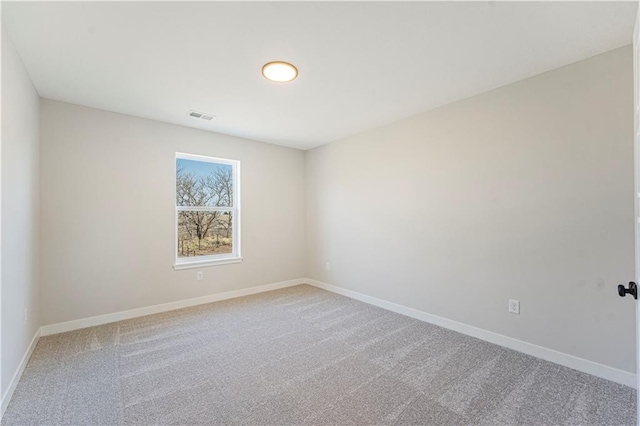 503 Woodview Dr, Raymore, MO 64083 - spare room with light carpet and baseboards