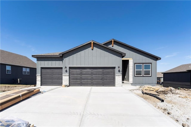 view of front of property featuring board and batten siding, concrete driveway, and an attached garage
