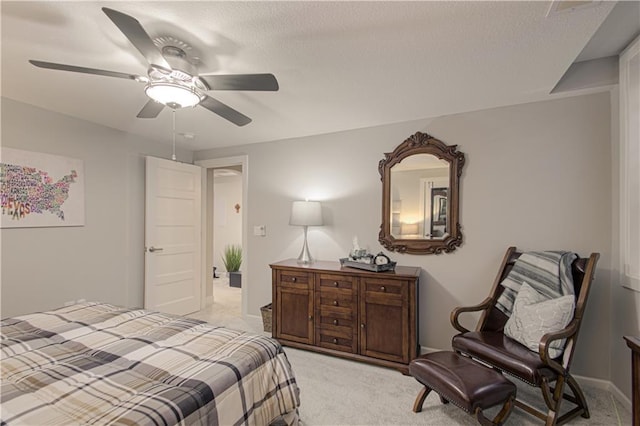 bedroom with a ceiling fan and light colored carpet