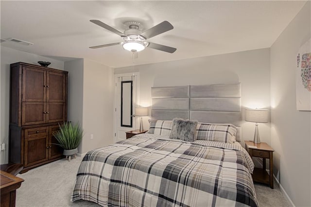 bedroom featuring baseboards, ceiling fan, light carpet, and visible vents