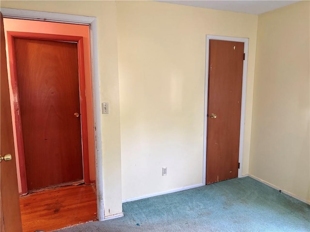 interior space featuring carpet floors and baseboards