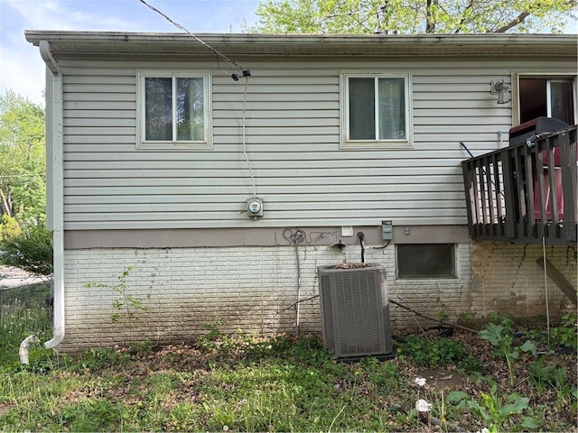 view of home's exterior with a deck and central AC unit