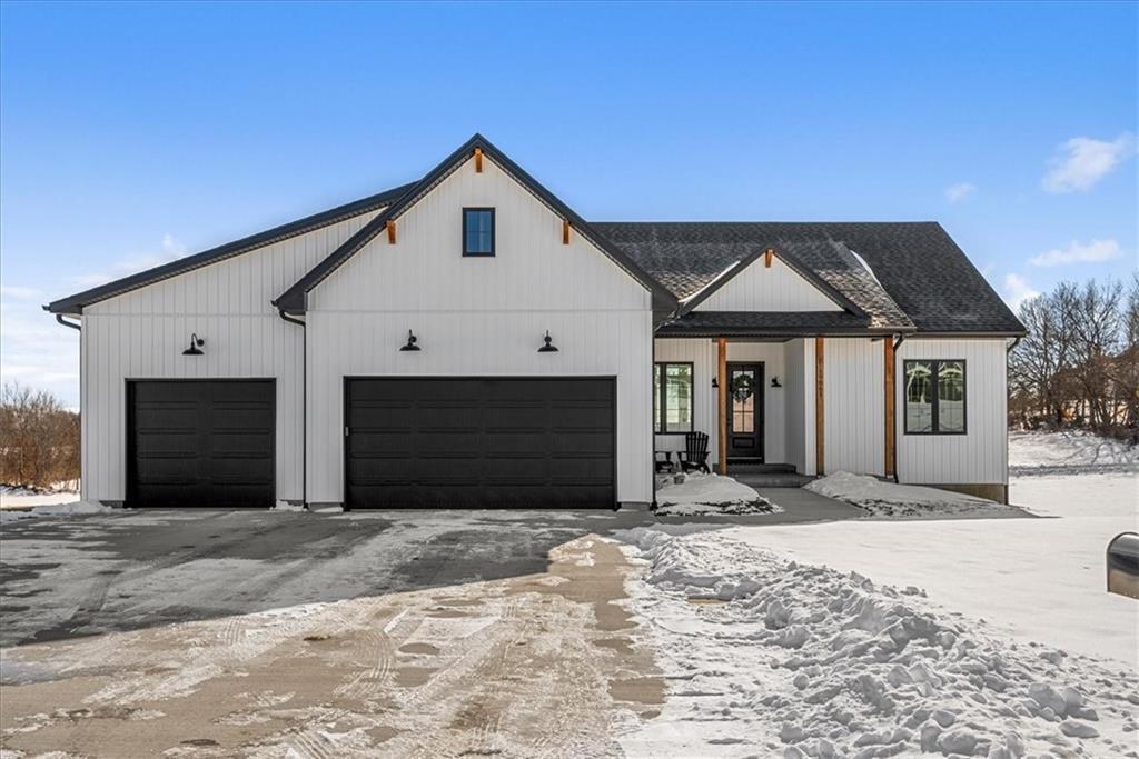 modern inspired farmhouse with driveway and roof with shingles